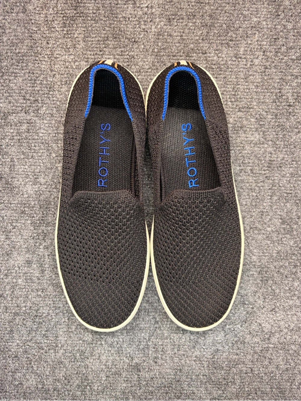 Rothy's women’s Black Slip-On Sneakers with Blue Trim